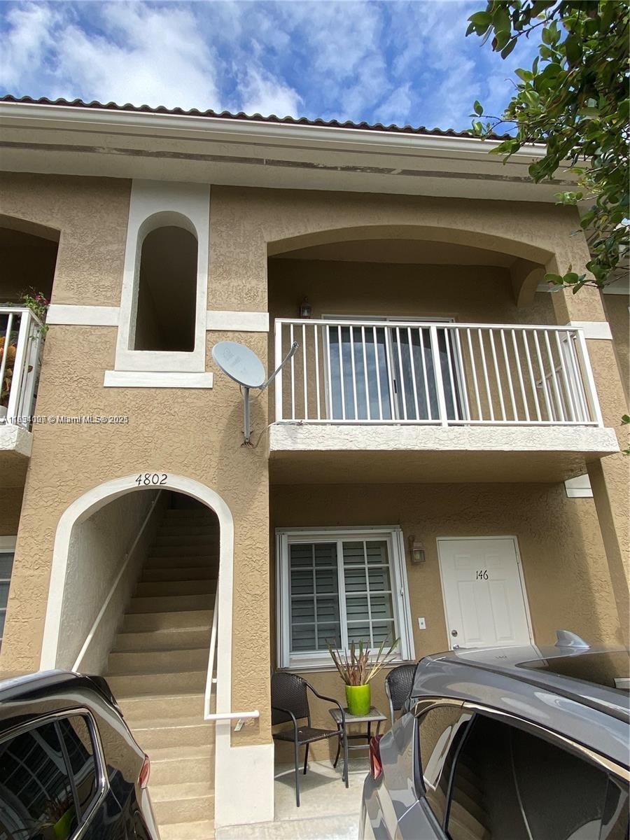 4802 Washington Street, Unit 14 Hollywood, FL 33021 - Photo 1 of 14 a front view of a house with parking space