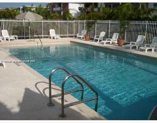 4802 Washington Street, Unit 14 Hollywood, FL 33021 - Photo 14 of 14 a view of a lake with a table and chairs