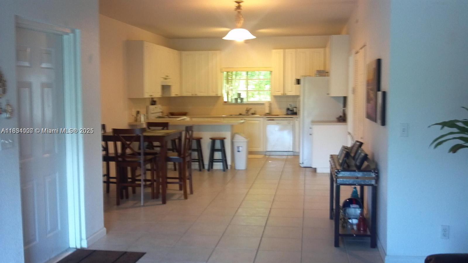 4802 Washington Street, Unit 14 Hollywood, FL 33021 - Photo 5 of 14 a very nice looking dining room with kitchen island furniture a sink and a window
