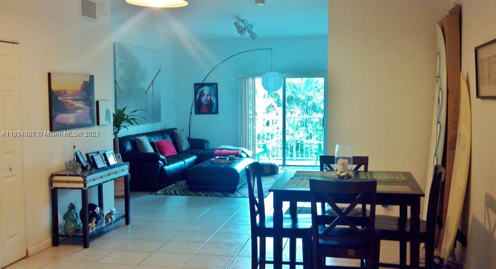4802 Washington Street, Unit 14 Hollywood, FL 33021 - Photo 7 of 14 a living room with furniture and a window
