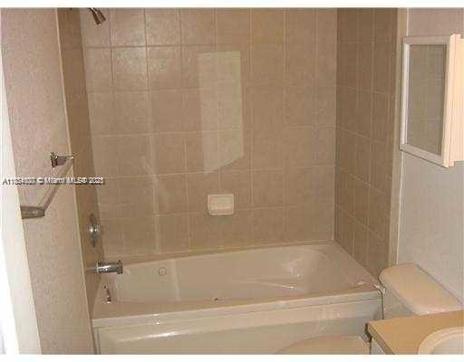 4802 Washington Street, Unit 14 Hollywood, FL 33021 - Photo 10 of 14 a bathroom with a bathtub