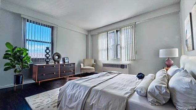 a bedroom with a bed and a potted plant