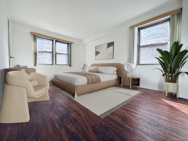 a bedroom with furniture and a large window