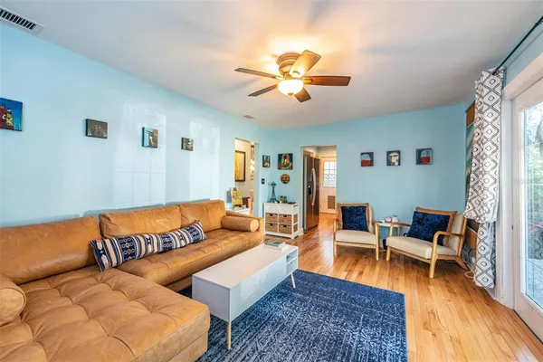 a living room with furniture and wooden floor