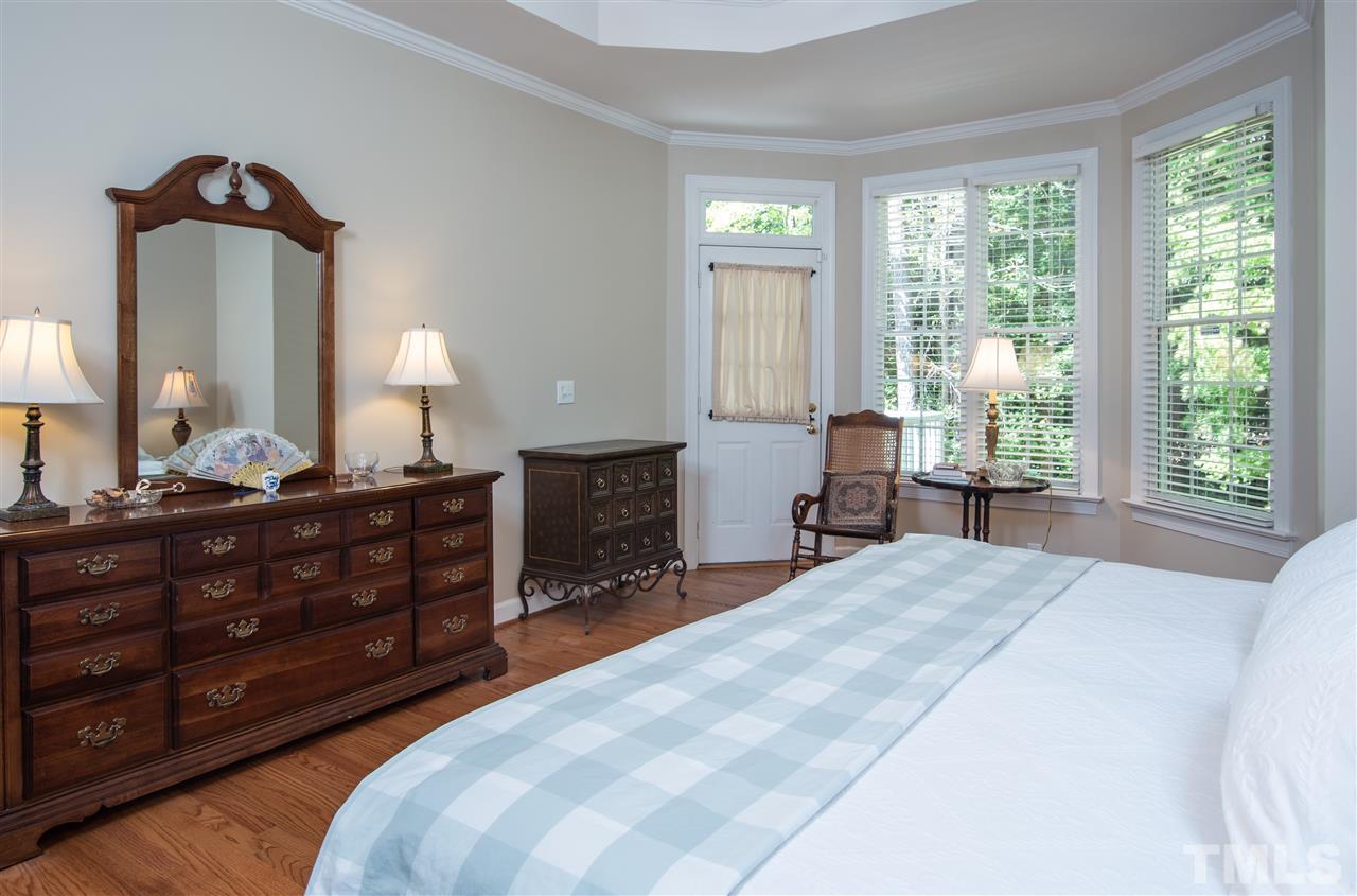 5817 Orchid Valley Road Raleigh, NC 27613 - Photo 13 of 25 a bedroom with a bed and a mirror on dresser