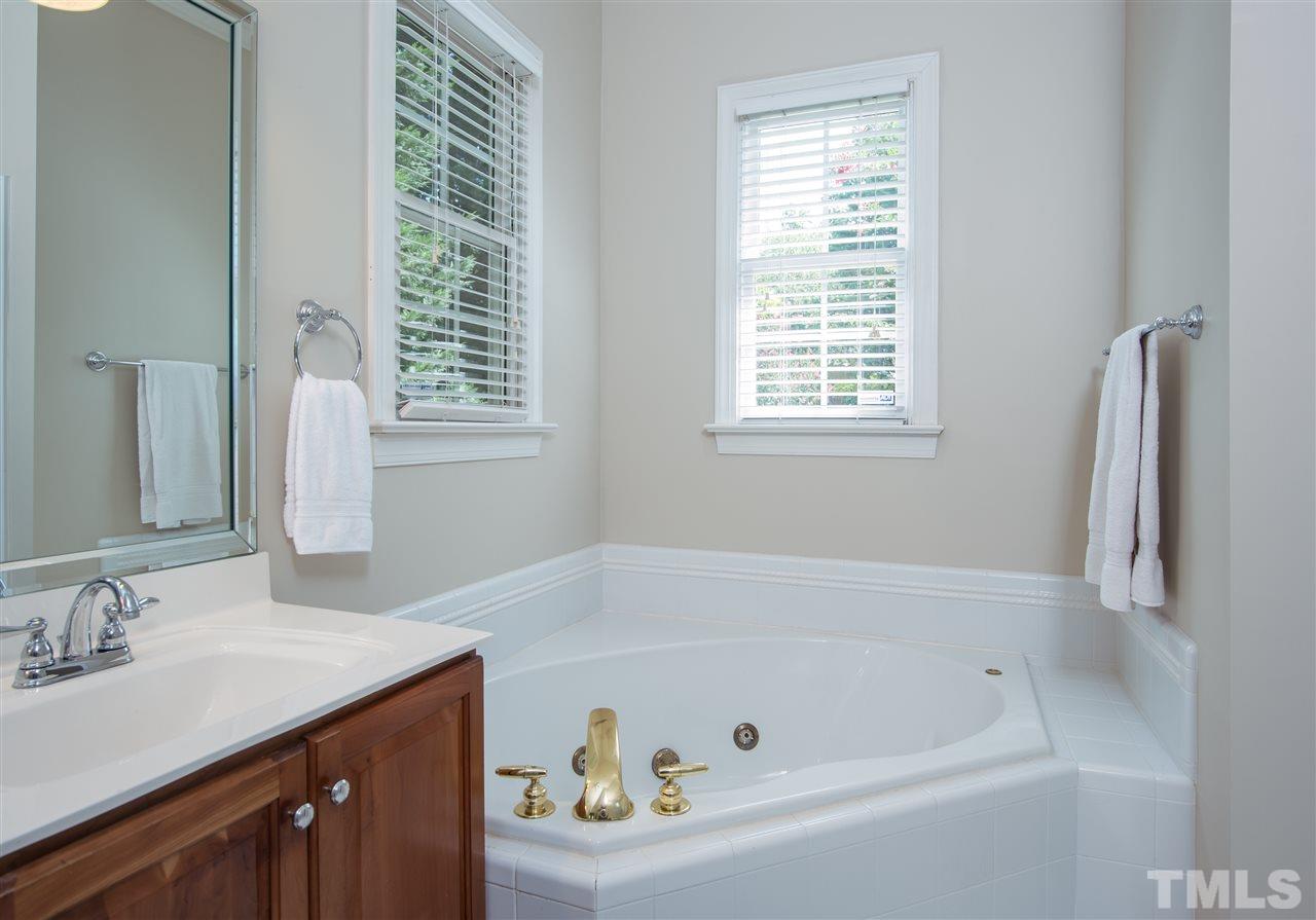 5817 Orchid Valley Road Raleigh, NC 27613 - Photo 14 of 25 a white bath tub sitting next to a white sink