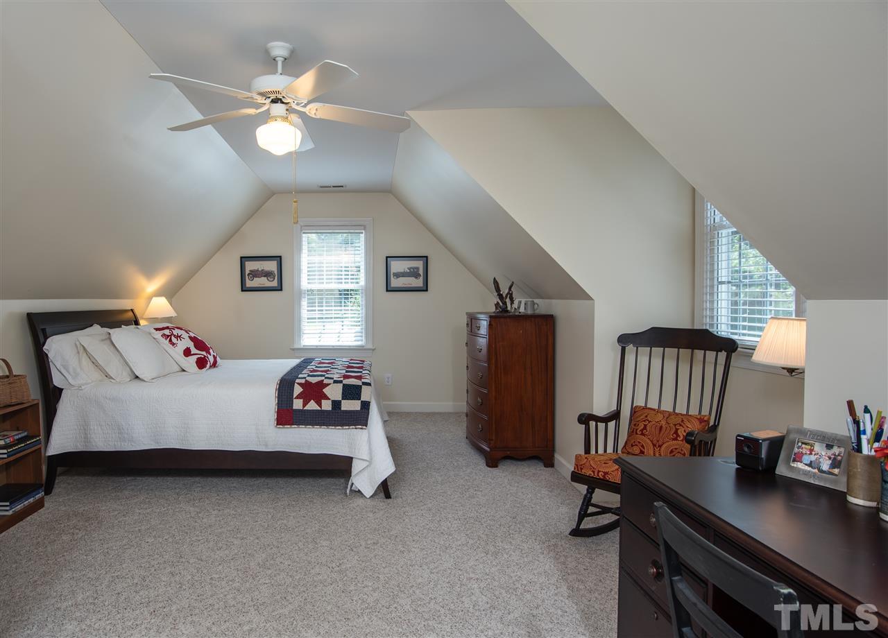 5817 Orchid Valley Road Raleigh, NC 27613 - Photo 16 of 25 a bedroom with bed and a chandelier