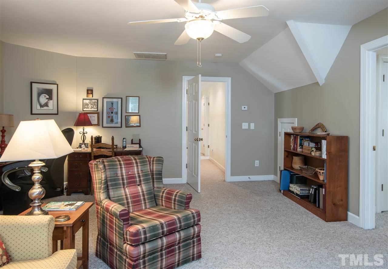 5817 Orchid Valley Road Raleigh, NC 27613 - Photo 18 of 25 a living room with furniture and a baby crib