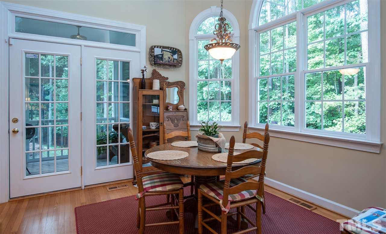 5817 Orchid Valley Road Raleigh, NC 27613 - Photo 8 of 25 a view of a dining room with furniture window and wooden floor