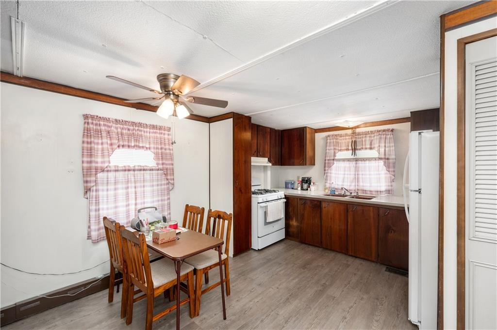 130 Kaiser Road Butler, PA 16002 - Photo 7 of 24 a kitchen with stainless steel appliances granite countertop a stove a refrigerator a sink dishwasher with a dining table and chairs