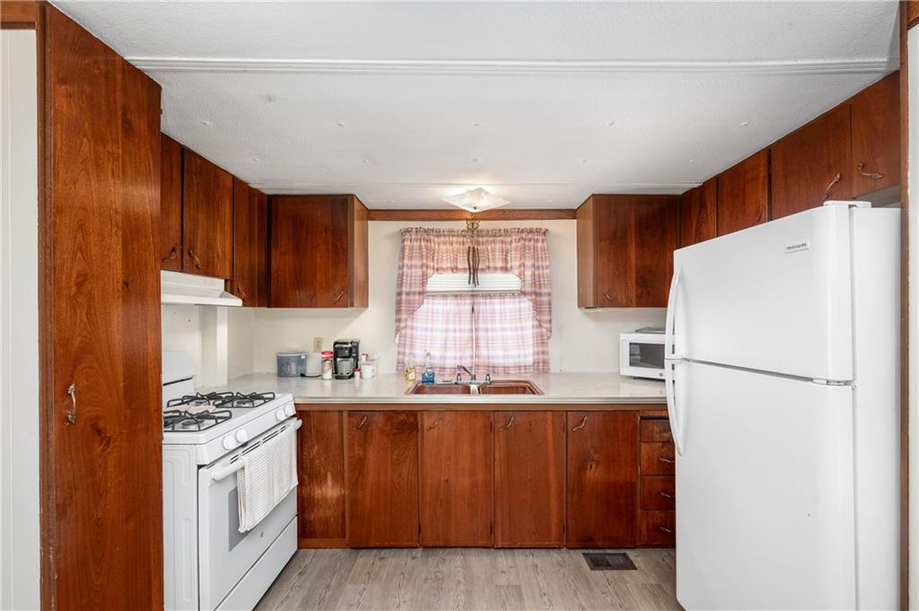 130 Kaiser Road Butler, PA 16002 - Photo 8 of 24 a kitchen with a sink a refrigerator and window