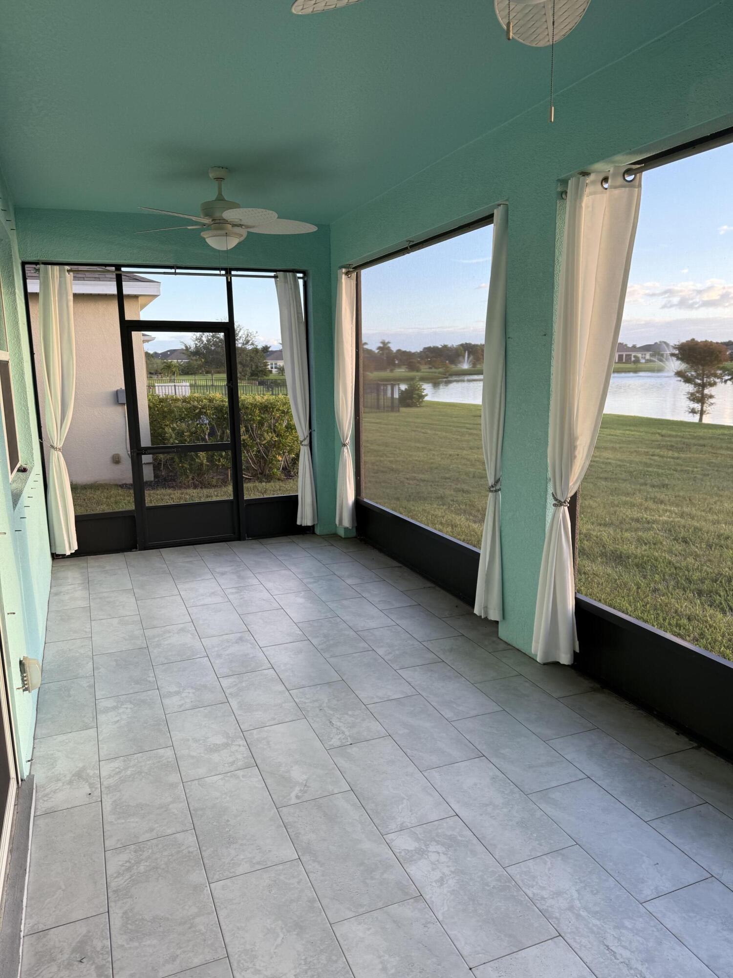 2608 Crowned Eagle Circle Southwest Vero Beach, FL 32962 - Photo 11 of 13 a view of an empty room with a fireplace and a large window