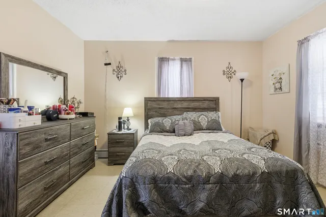 a bedroom with a bed and a dresser