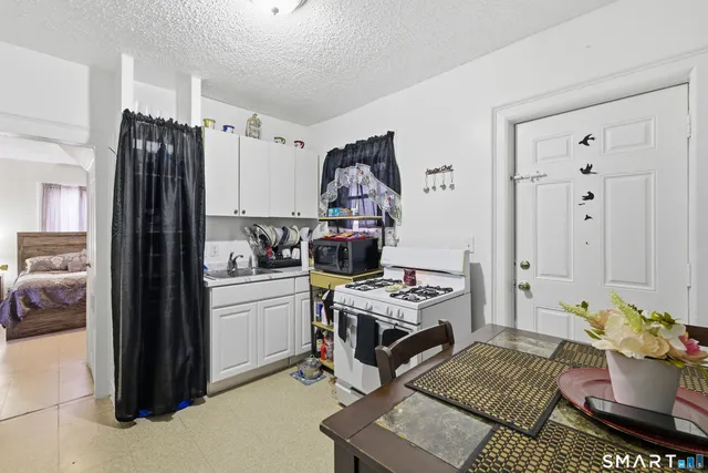 a kitchen with a refrigerator and a stove