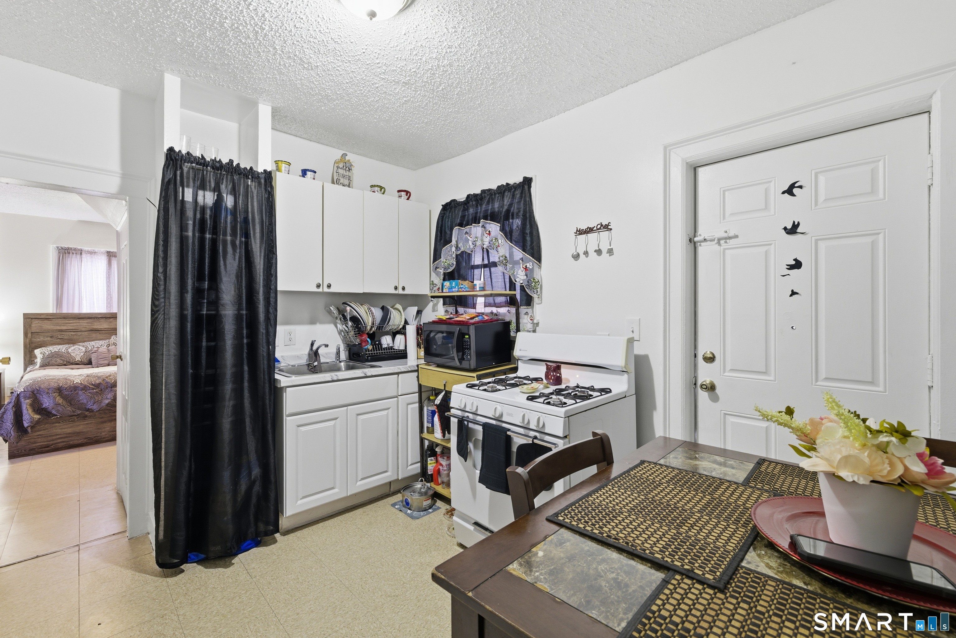218 Martin Street Hartford, CT 06120 - Photo 16 of 38 a kitchen with a refrigerator and a stove