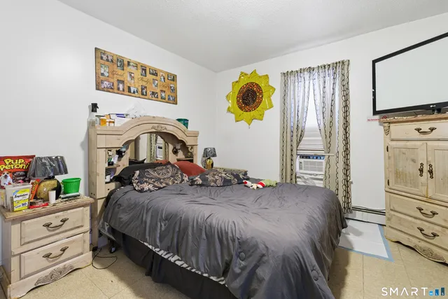 a bedroom with a bed and a tv in it