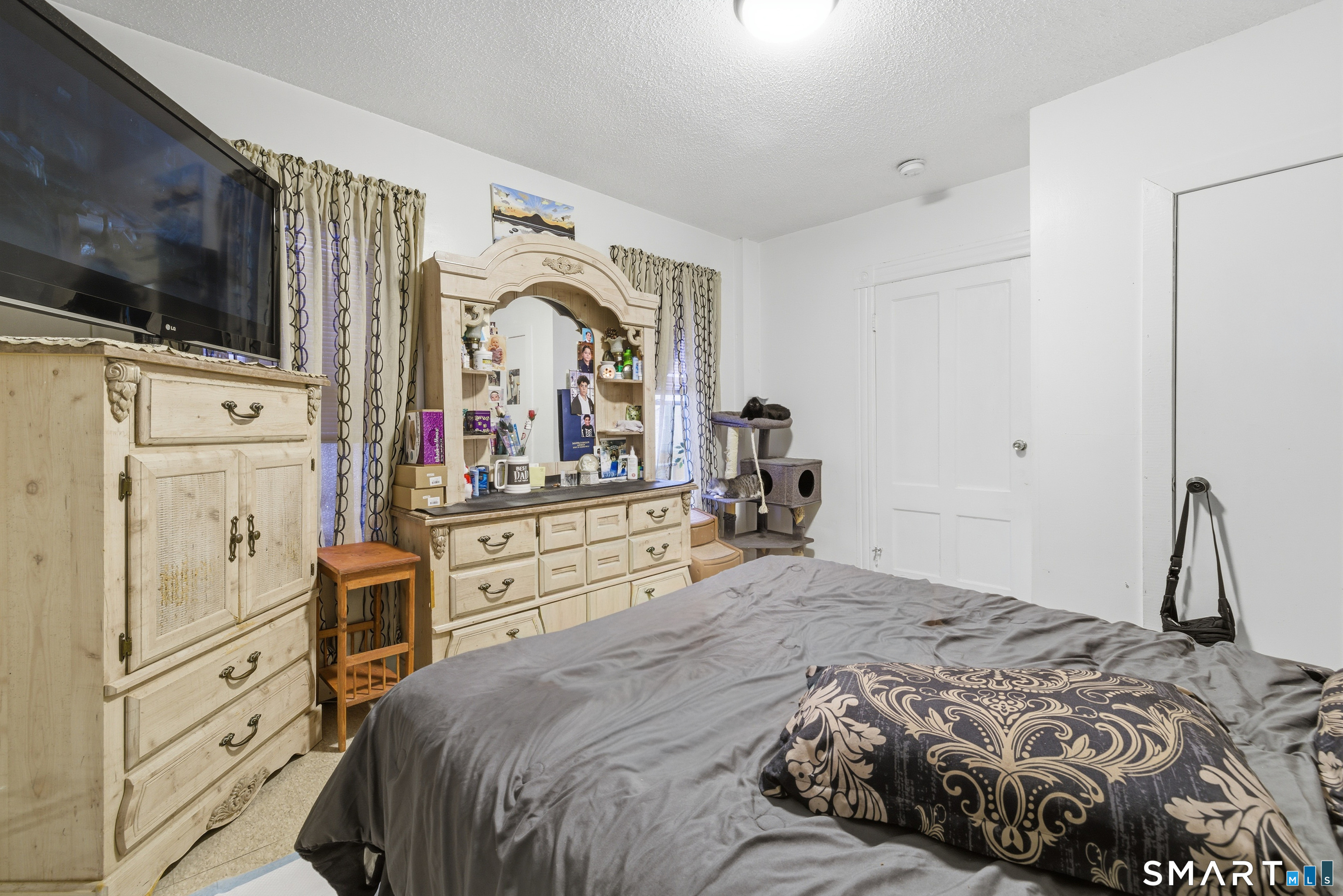 218 Martin Street Hartford, CT 06120 - Photo 20 of 38 a bedroom with a bed and a flat tv screen on dresser