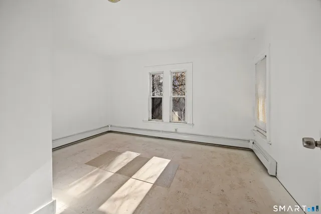 a view of a room with wooden floor