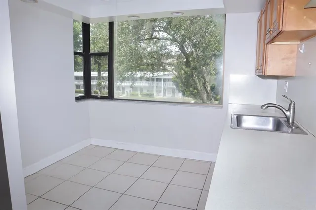 a view of a kitchen with a sink and a window