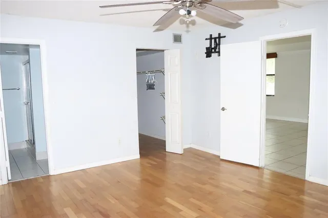 a view of a chandelier fan and entryway