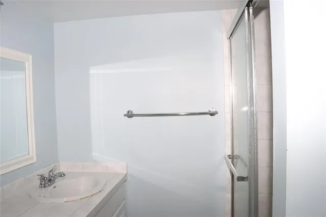 a bathroom with a sink and shower