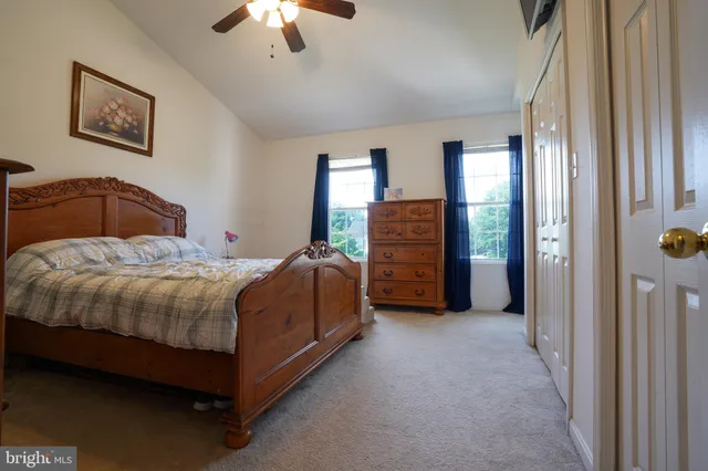a spacious bedroom with a bed and a chandelier
