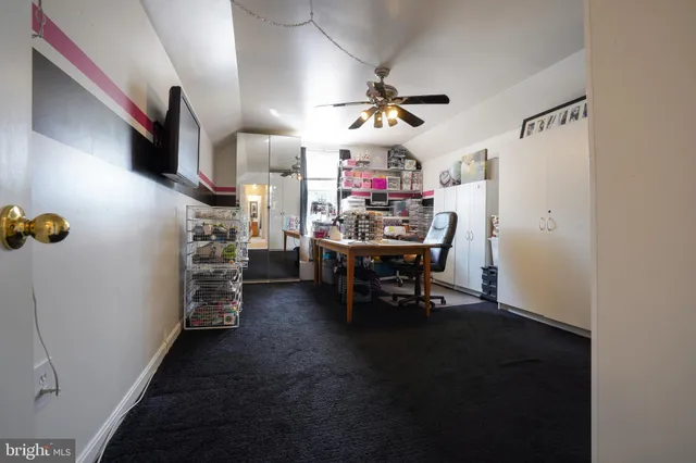 a view of a livingroom with furniture and a ceiling fan