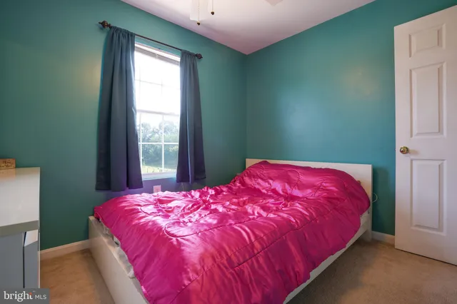 a bedroom with a bed and window