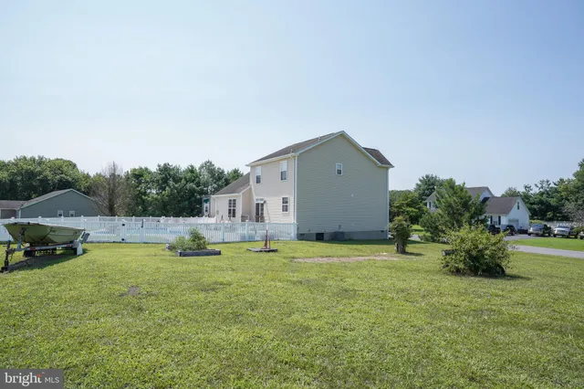 a view of a house with a yard and sitting area