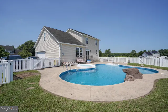 a view of a house with swimming pool and a yard