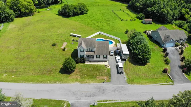an aerial view of a house with a yard and lake view