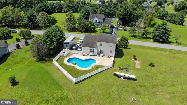 an aerial view of a house with a swimming pool