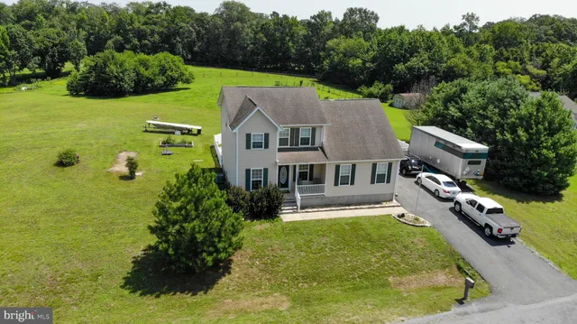 a aerial view of a house with swimming pool garden and patio
