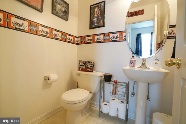 a bathroom with a sink mirror vanity and toilet