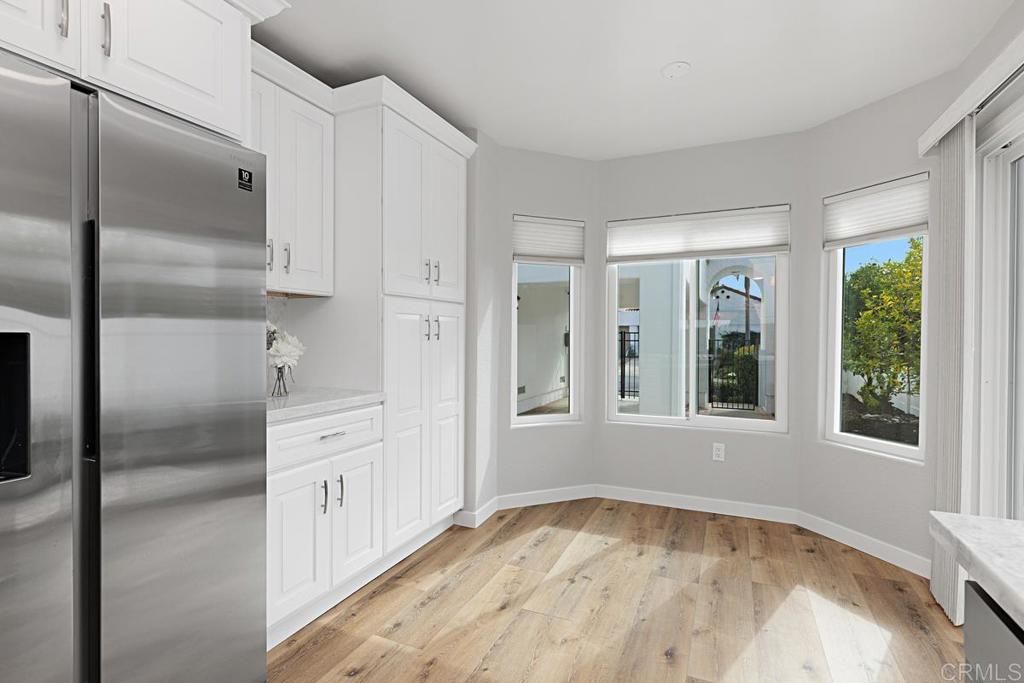 4710 Galicia Way Oceanside, CA 92056 - Photo 13 of 46 a view of an empty room with window and wooden floor