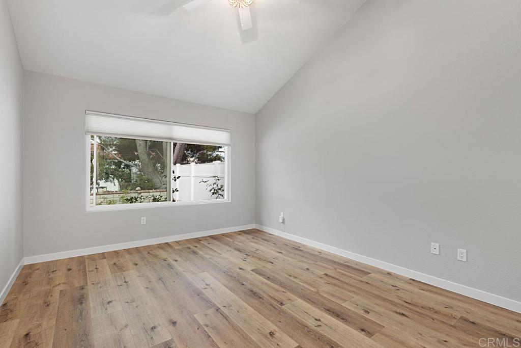 4710 Galicia Way Oceanside, CA 92056 - Photo 15 of 46 a view of an empty room with wooden floor and a window