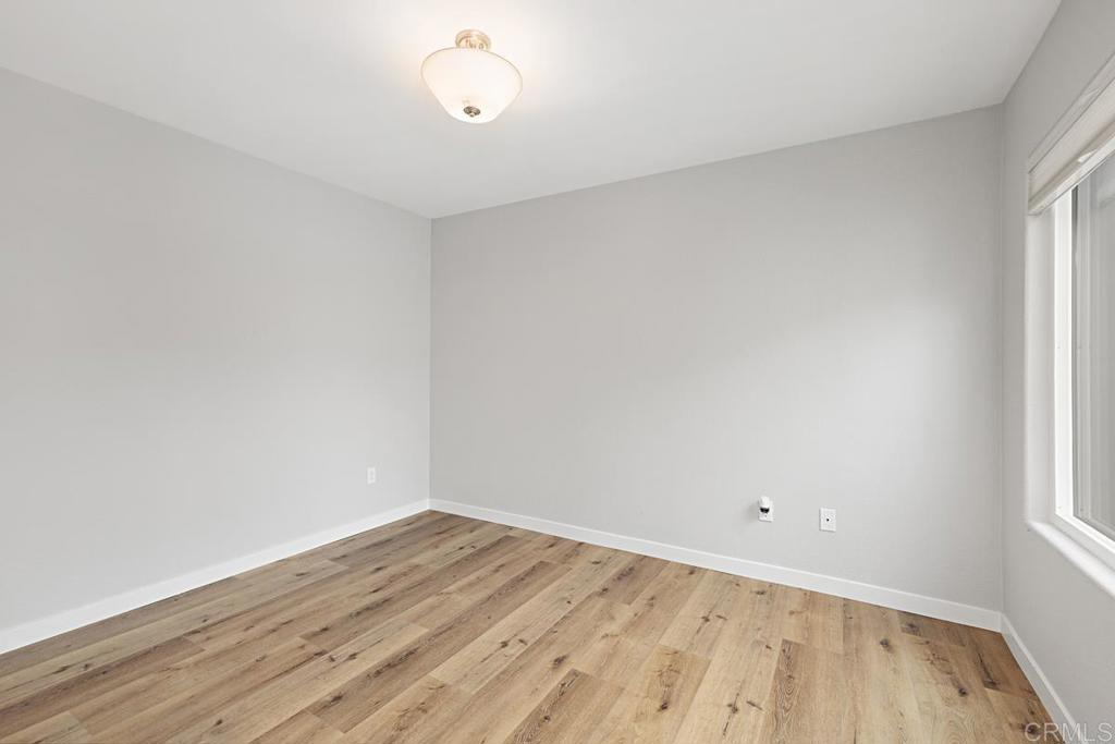 4710 Galicia Way Oceanside, CA 92056 - Photo 19 of 46 wooden floor in an empty room with a window