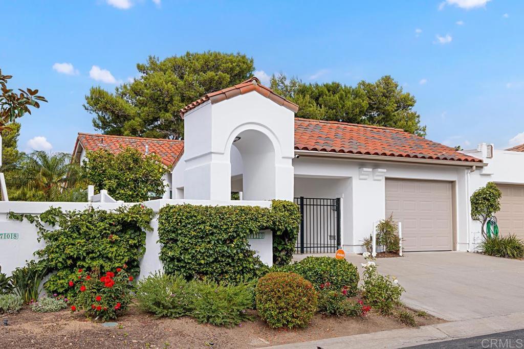 4710 Galicia Way Oceanside, CA 92056 - Photo 2 of 46 a front view of a house with a garden
