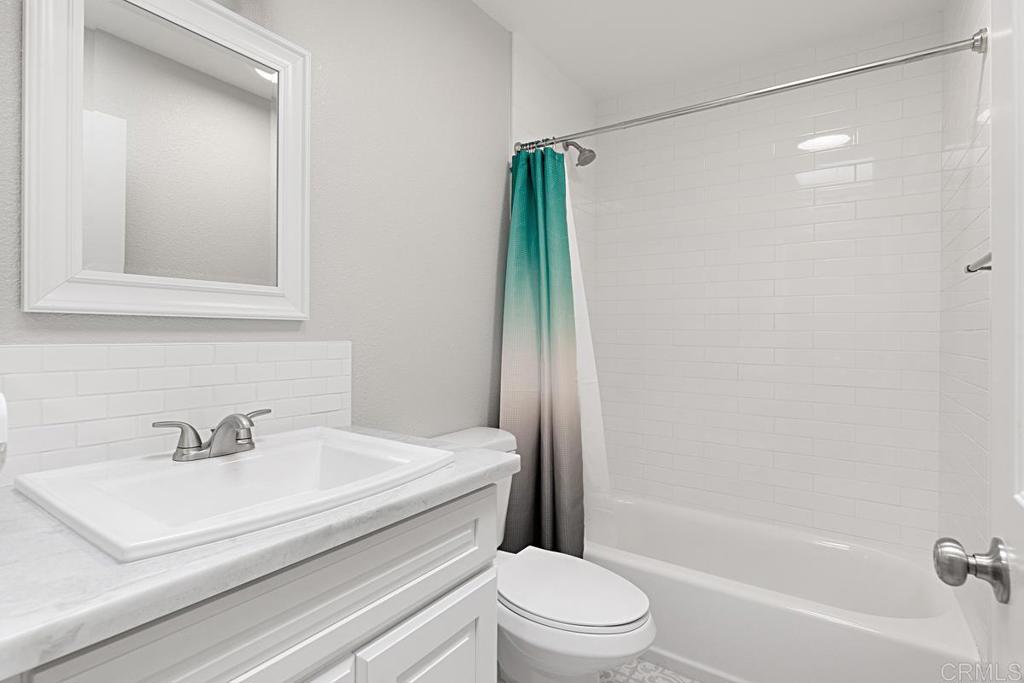 4710 Galicia Way Oceanside, CA 92056 - Photo 21 of 46 a bathroom with a sink toilet and shower