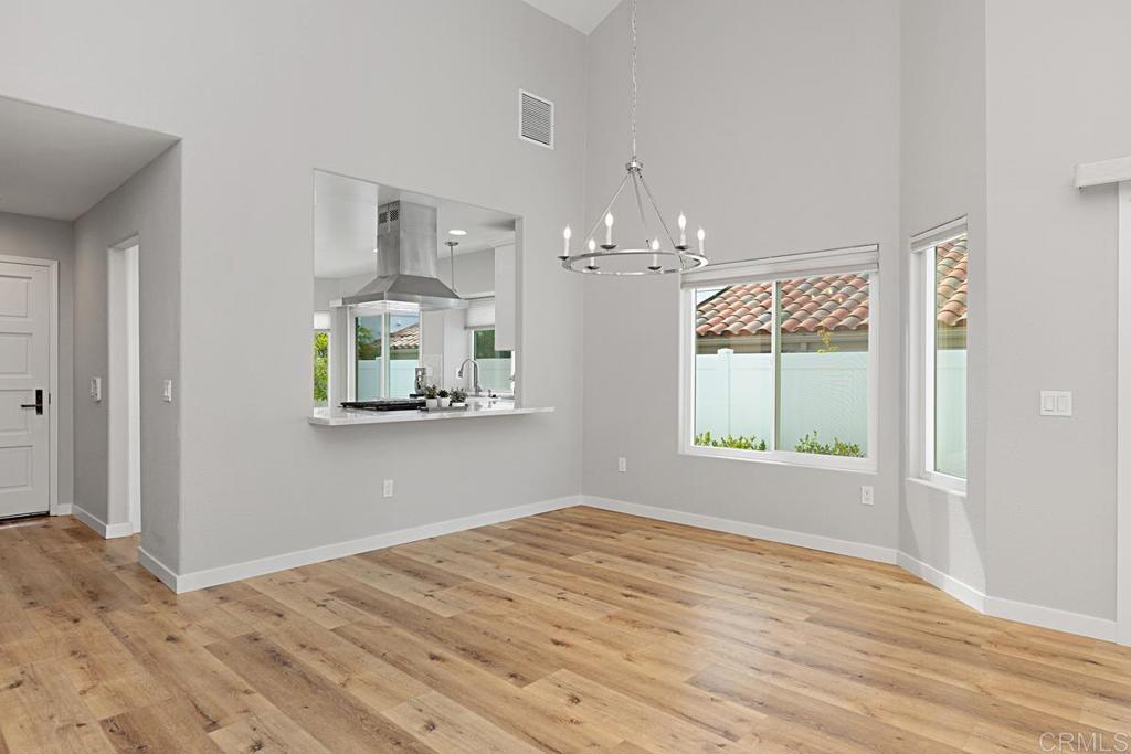 4710 Galicia Way Oceanside, CA 92056 - Photo 8 of 46 a view of empty room with wooden floor and fan