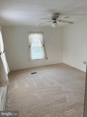 an empty room with a empty space and windows