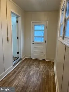 a view of an empty room with wooden floor