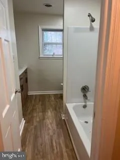 a bathroom with a bathtub and shower