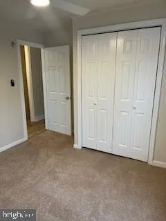 a view of an empty room and closet area