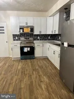 a kitchen with granite countertop a stove a sink and a granite counter tops