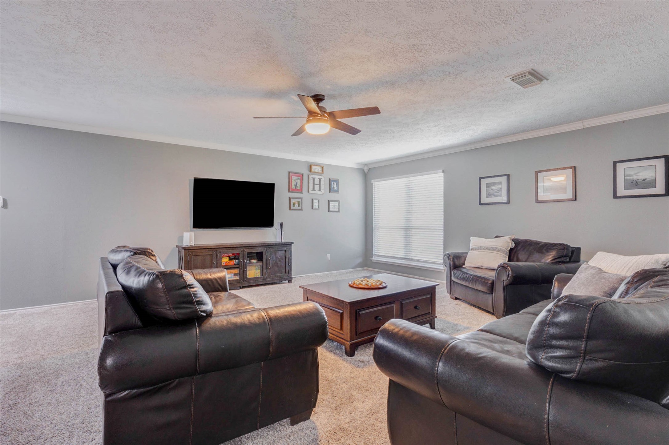 9215 Landry Boulevard Spring, TX 77379 - Photo 24 of 42 A large window fills the game room with natural light, while the sizable wall space easily accommodates a large media console, mounted television, or custom entertainment setup.