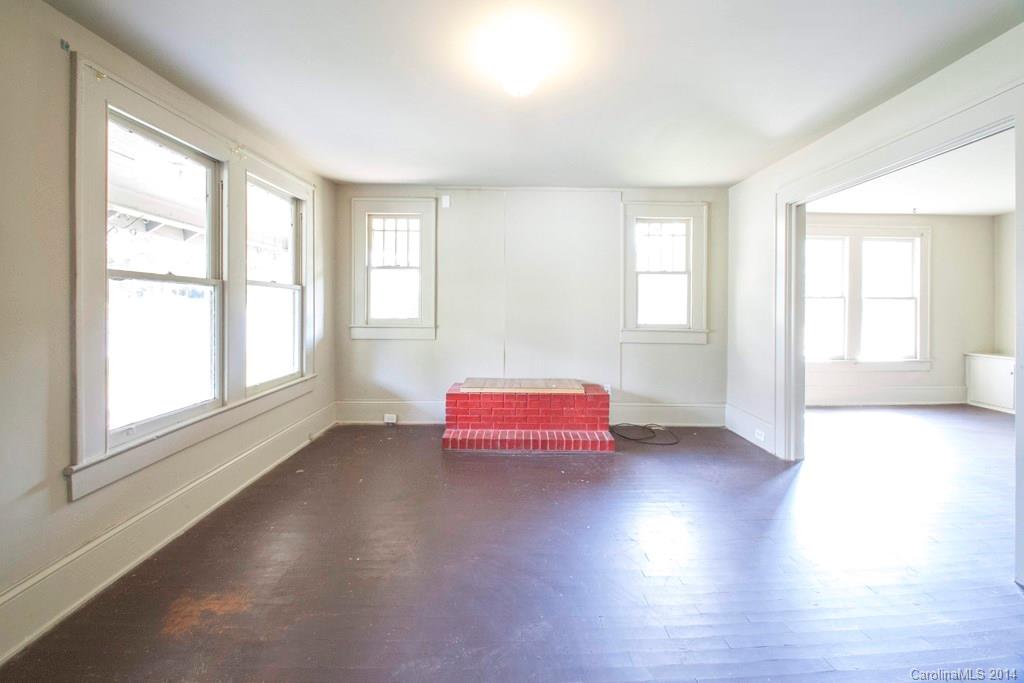 3101 Tuckaseegee Road Charlotte, NC 28208 - Photo 2 of 13 an empty room with wooden floor and windows