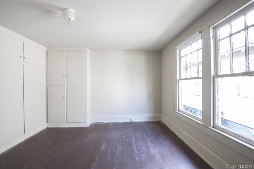 3101 Tuckaseegee Road Charlotte, NC 28208 - Photo 11 of 13 an empty room with wooden floor and windows