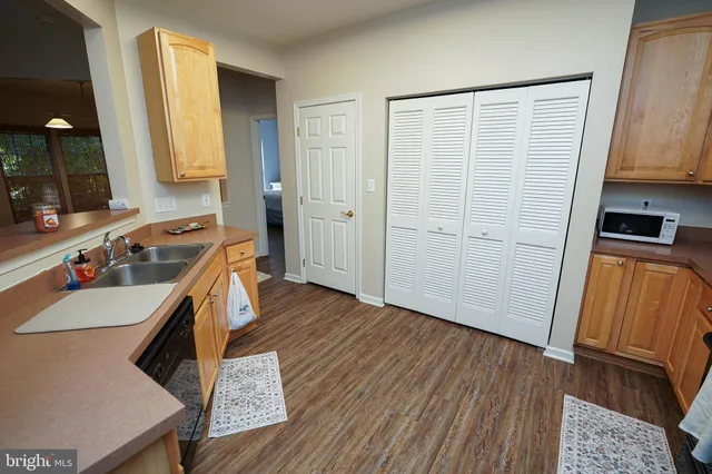 a kitchen with wooden floors and a sink