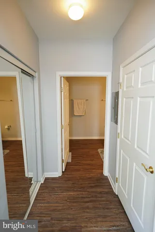 a view of a hallway with wooden floor